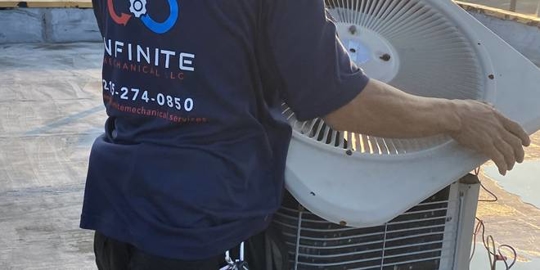 A technician repairs HVAC system components.