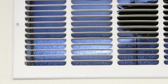 Close up of a wall return air vent.