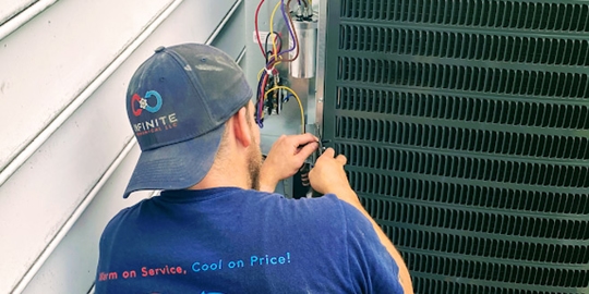 A technician is performing maintenance on an HVAC system